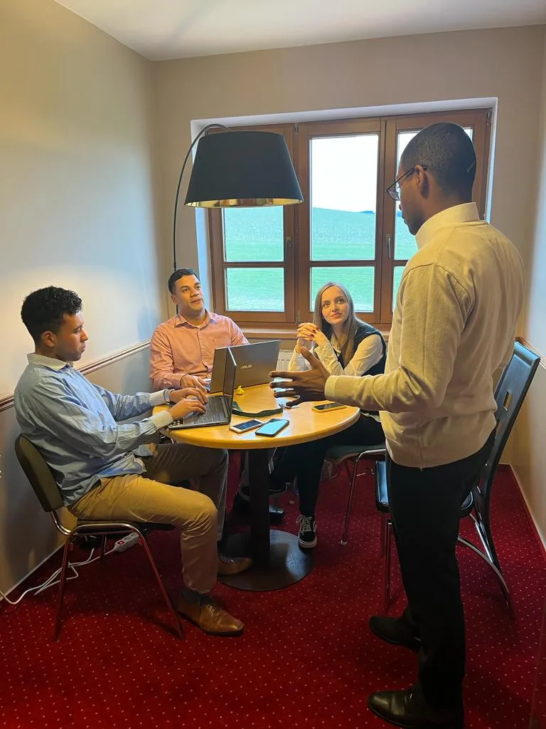 Pedro explaining things to a group of 3 people